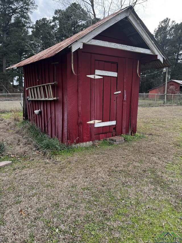 view of outbuilding featuring a lawn