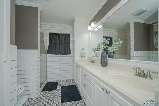 322 Roy Green Rd, Longview, TX 75602 - bathroom featuring tile walls, double vanity, ornamental molding, and a stall shower