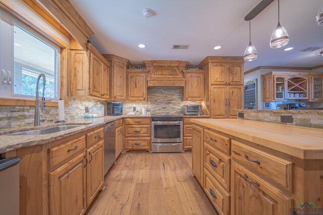 322 Roy Green Rd, Longview, TX 75602 - kitchen featuring stainless steel appliances, butcher block counters, custom exhaust hood, tasteful backsplash, and recessed lighting