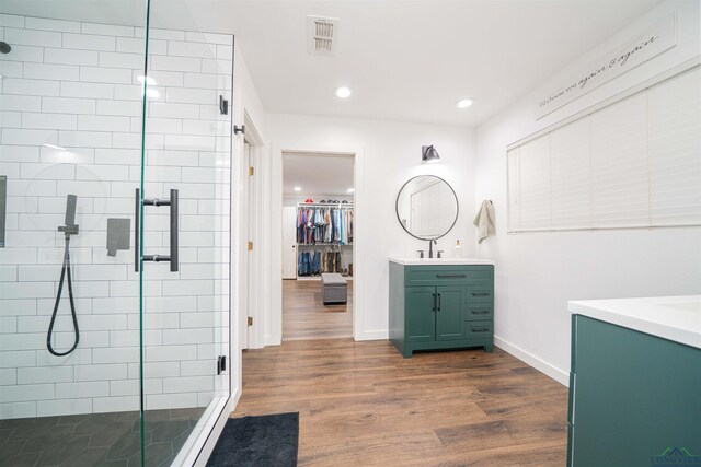 322 Roy Green Rd, Longview, TX 75602 - bathroom with vanity, a stall shower, wood finished floors, recessed lighting, and a spacious closet