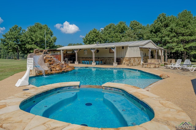322 Roy Green Rd, Longview, TX 75602 - view of pool with a patio, a water slide, a pool with connected hot tub, and exterior bar