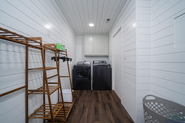 322 Roy Green Rd, Longview, TX 75602 - laundry area featuring washing machine and clothes dryer, dark wood-type flooring, cabinet space, wood walls, and recessed lighting