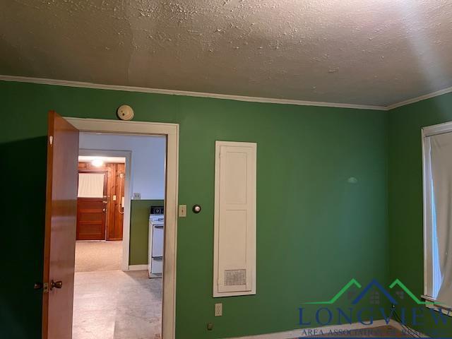 unfurnished bedroom featuring ornamental molding and a textured ceiling