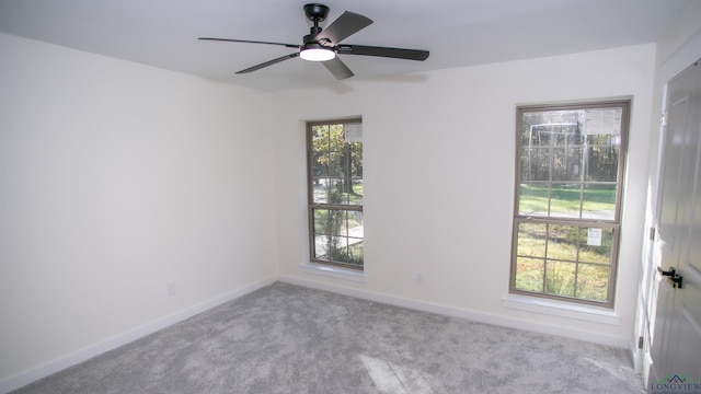 unfurnished room featuring light colored carpet and ceiling fan