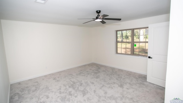 spare room featuring ceiling fan and light colored carpet