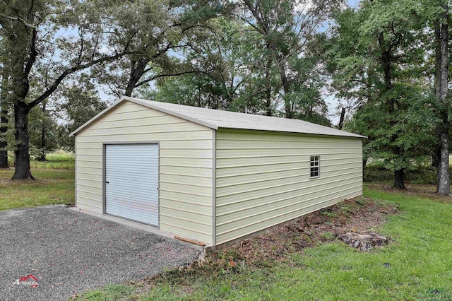 view of outbuilding featuring a garage and a yard