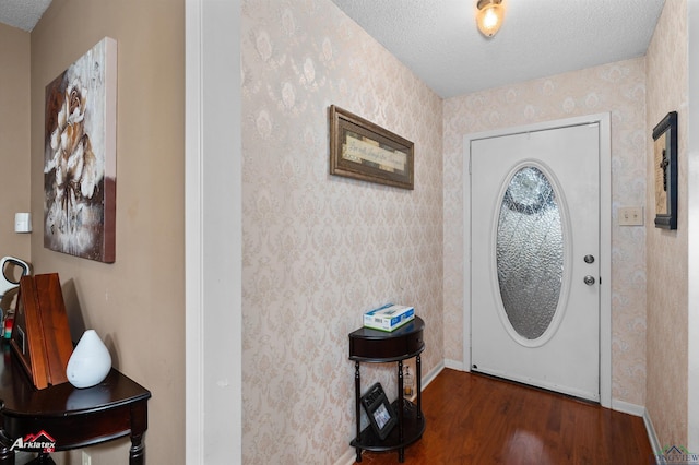 entrance foyer featuring dark wood-type flooring and a textured ceiling