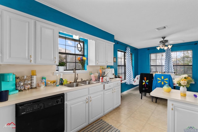 kitchen featuring sink, white cabinetry, a healthy amount of sunlight, and black dishwasher