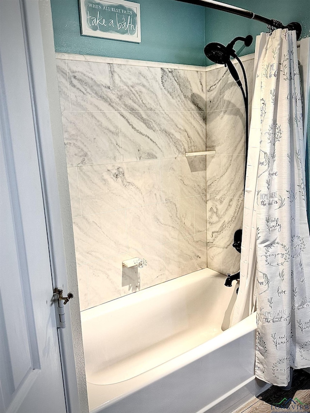 bathroom with shower / bath combination with curtain