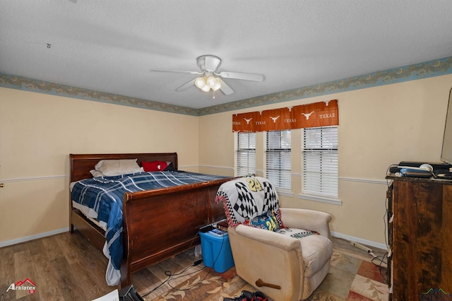 bedroom featuring ceiling fan, a textured ceiling, and hardwood / wood-style flooring