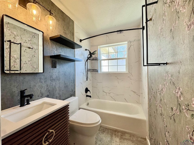 full bathroom featuring vanity, tiled shower / bath combo, toilet, and a textured ceiling