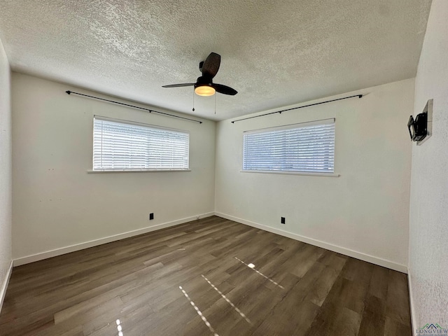 empty room featuring ceiling fan, wood-type flooring, and a textured ceiling