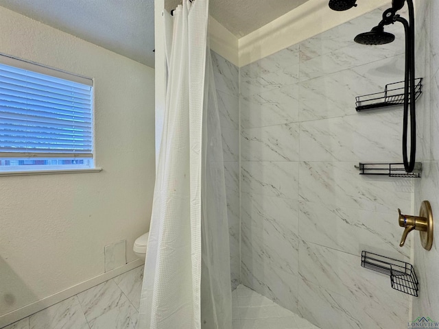 bathroom with a shower with curtain and toilet