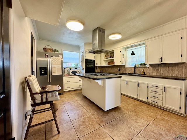 kitchen featuring a breakfast bar, sink, white cabinetry, appliances with stainless steel finishes, and island exhaust hood