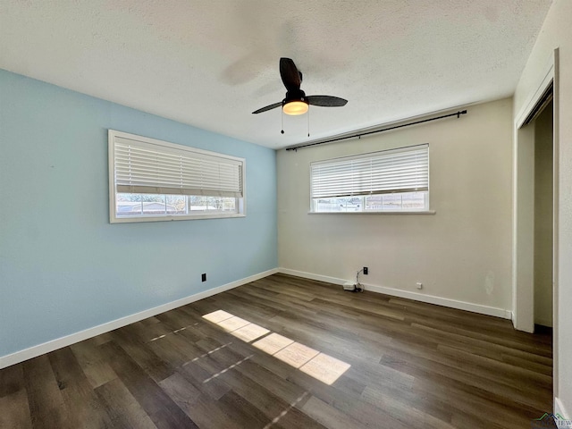 unfurnished bedroom with dark hardwood / wood-style flooring, a textured ceiling, a closet, and ceiling fan