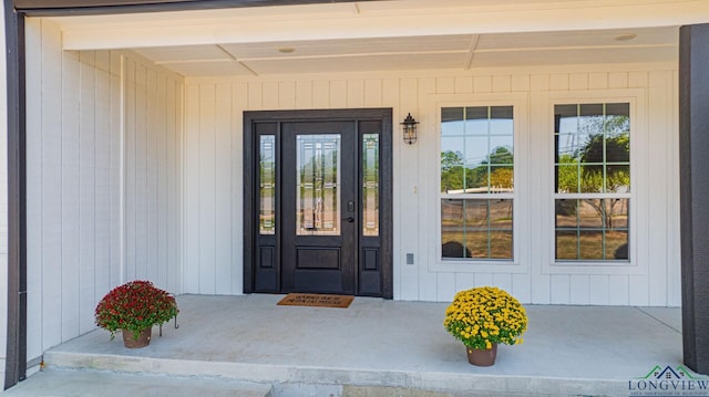 view of exterior entry with covered porch