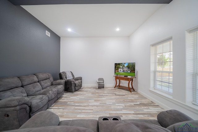 living room with baseboards, visible vents, light wood finished floors, and recessed lighting