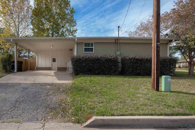 ranch-style home with a front lawn and a carport