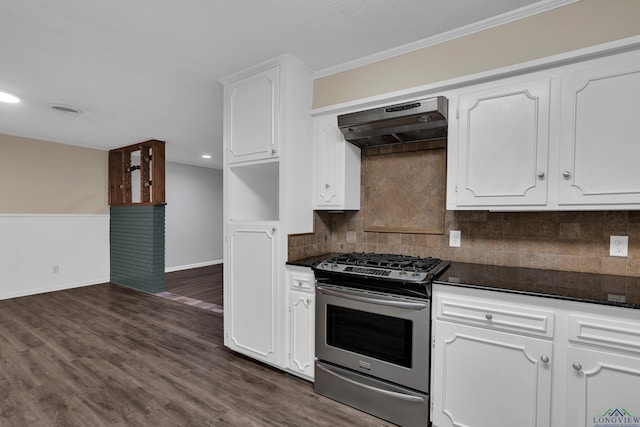 kitchen with stainless steel gas range, dark wood-type flooring, wall chimney range hood, crown molding, and white cabinets