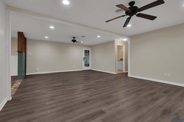 unfurnished living room with dark hardwood / wood-style flooring and ceiling fan