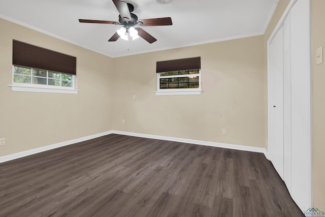 unfurnished room featuring dark hardwood / wood-style floors, ceiling fan, and crown molding