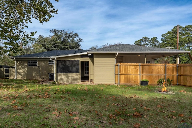 rear view of property featuring a yard