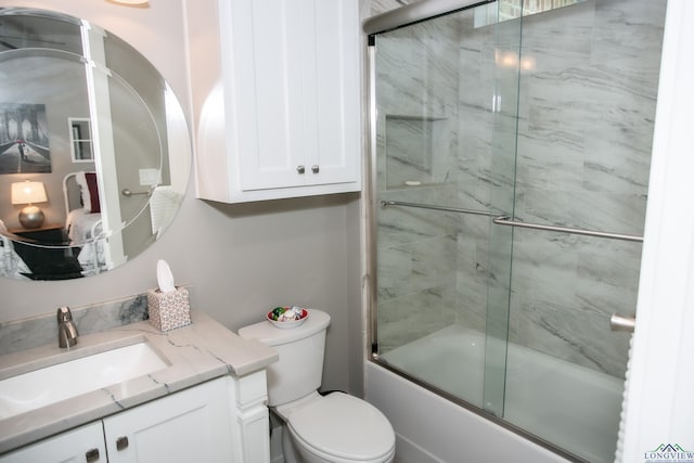 bathroom with enclosed tub / shower combo, toilet, and vanity