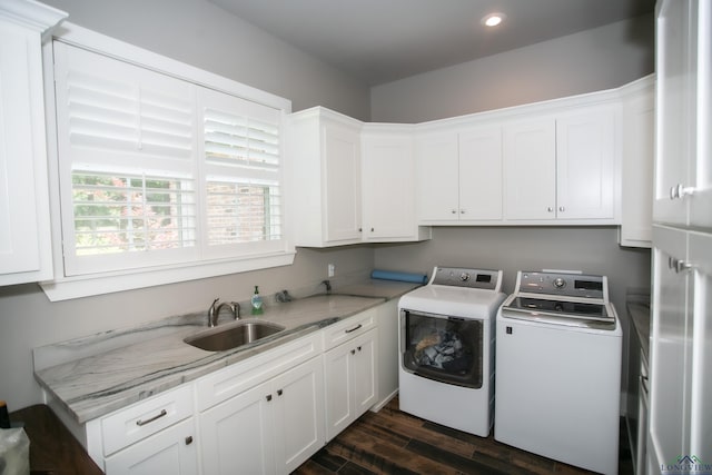 washroom featuring washing machine and dryer, a sink, cabinet space, recessed lighting, and dark wood-style flooring