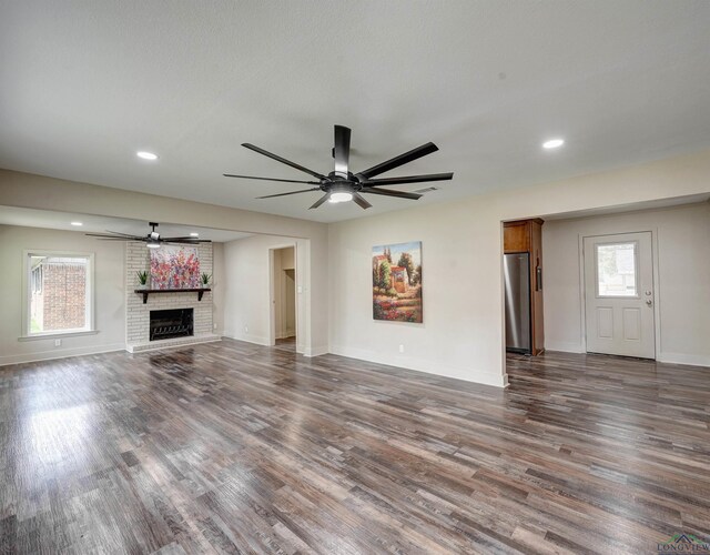 3902 Hazel St, Texarkana, TX 75503 - unfurnished living room with a ceiling fan, dark wood finished floors, a fireplace, baseboards, and recessed lighting