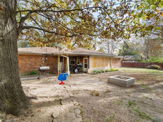 rear view of property featuring a sunroom