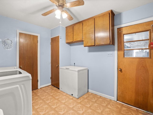 laundry area featuring ceiling fan, washer and dryer, and cabinets