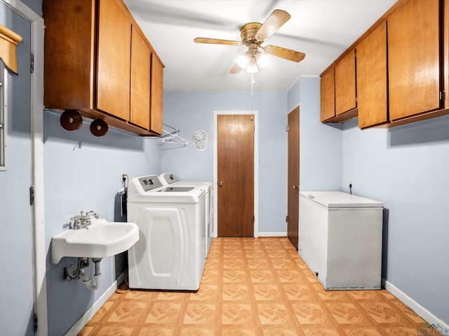 washroom with ceiling fan, cabinets, and washing machine and clothes dryer