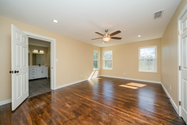 spare room with dark hardwood / wood-style floors and ceiling fan