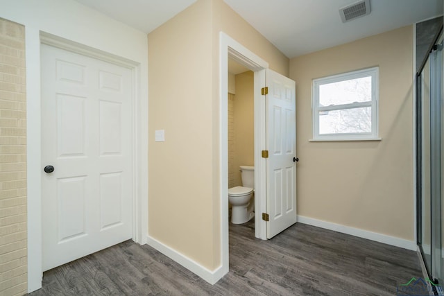 bathroom with hardwood / wood-style floors and toilet