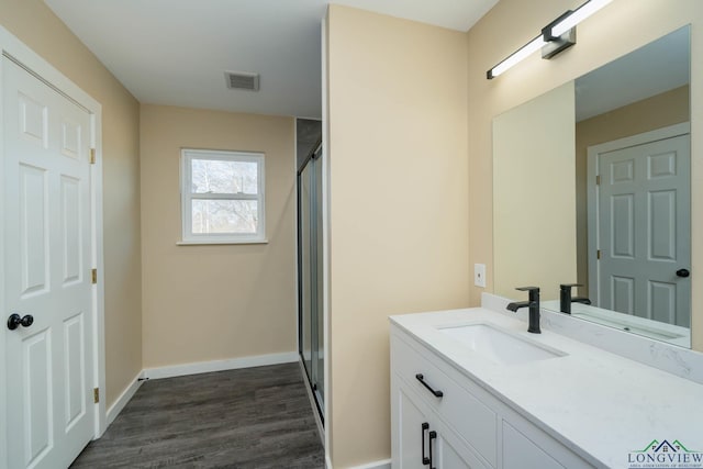 bathroom featuring vanity, hardwood / wood-style floors, and an enclosed shower