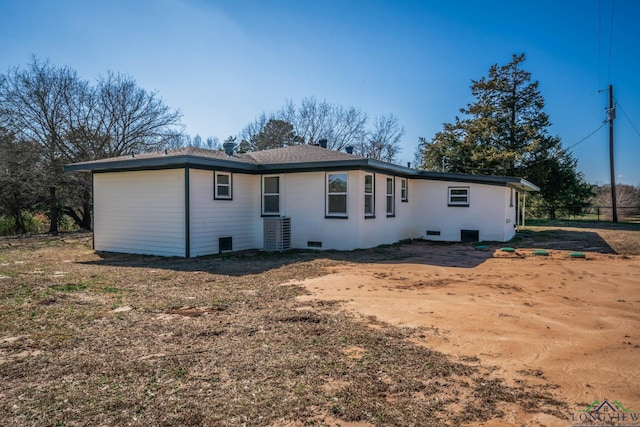 rear view of property featuring cooling unit