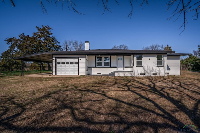 ranch-style house featuring a carport, a garage, and a front lawn