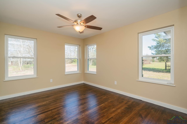 empty room featuring dark wood-type flooring and ceiling fan