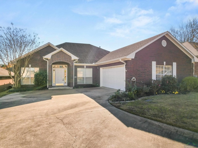 single story home with a garage and a front yard