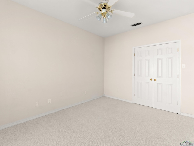 unfurnished bedroom featuring ceiling fan, a closet, and carpet floors