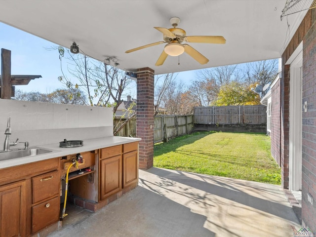 view of patio with ceiling fan and sink