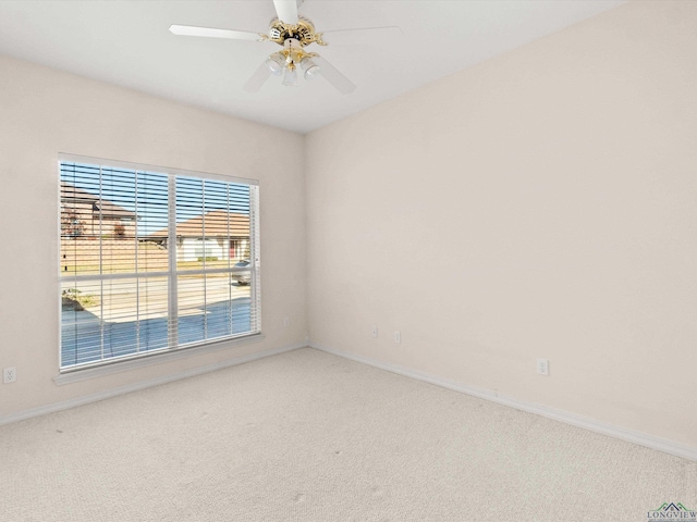 carpeted spare room with ceiling fan