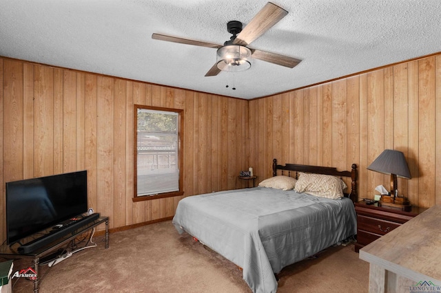 bedroom featuring ceiling fan, light colored carpet, a textured ceiling, and wooden walls