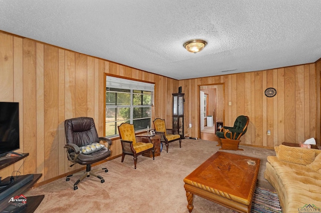 carpeted living room with a textured ceiling and wood walls