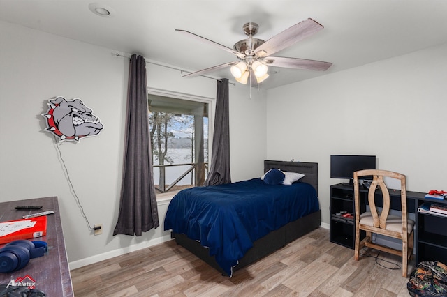 bedroom with light hardwood / wood-style floors and ceiling fan