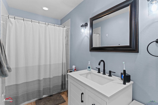 bathroom with vanity and wood-type flooring