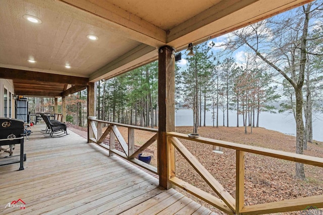 wooden deck featuring a water view