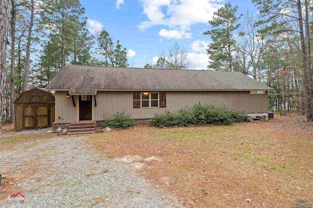 ranch-style house featuring a storage shed