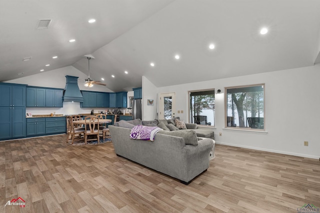 living room featuring high vaulted ceiling, light hardwood / wood-style floors, and ceiling fan