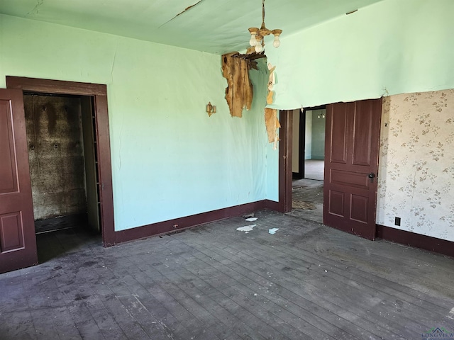 unfurnished room featuring dark wood-type flooring